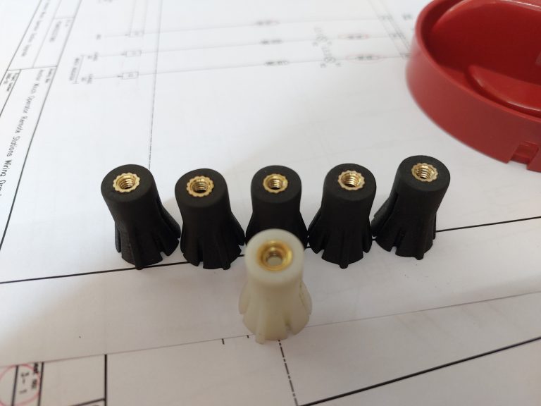 3D Printed Isolator Inserts (black) and Original Isolator Insert (white)